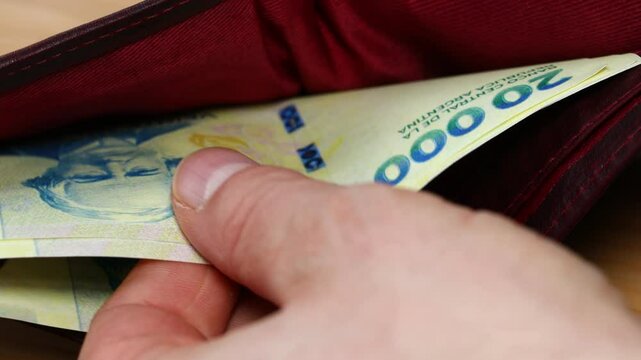 Argentina money. New banknotes of 20,000 Argentine pesos in wallet. Financial business concept. Close up
