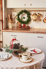 Christmas kitchen and table. Red, green and white decor christmas tree background. New Year celebration. Merry Christmas and Happy New Year.
