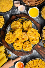 Raw Italian Tagliatelle Pasta. Cooking background. Italian food concept.