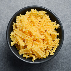 Dry Organic Mafalda Corta Pasta. Cooking background. Italian food concept.