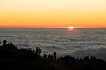 Obraz premium People above the clouds during sunrise