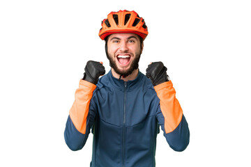 Young cyclist man over isolated chroma key background celebrating a victory in winner position