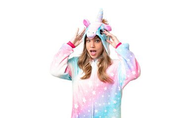 Young girl with unicorn pajamas over isolated chroma key background with surprise expression