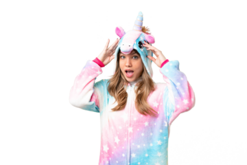 Young girl with unicorn pajamas over isolated chroma key background with surprise expression