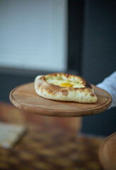 waiter serves khachapuri