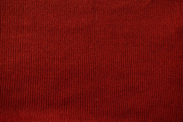 Detailed red knitted fabric background texture.