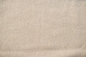 Detailed white cream or vanilla knitted fabric background texture.