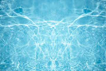 Blue water with ripples on the surface. Defocus blurred transparent blue colored clear calm water surface texture with splashes and bubbles. Water waves with shining pattern texture background.