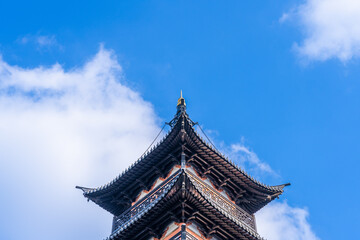 Ancient Chinese pagoda under blue sky and white clouds