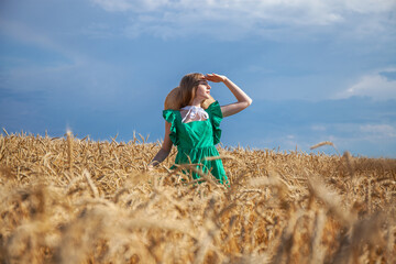 Young beautiful blonde girl posing in a wheat field