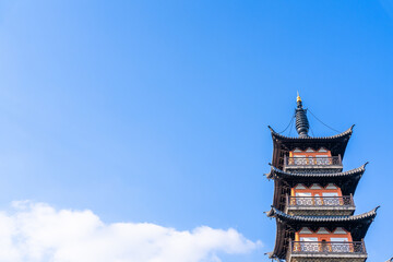 Ancient Chinese pagoda under blue sky and white clouds