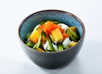 Close-up of mango cucumber salad isolated on white background