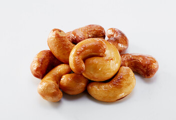 Close up of roasted cashew nuts isolated on white background