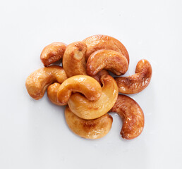 Close up of roasted cashew nuts isolated on white background