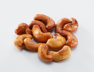 Close up of roasted cashew nuts isolated on white background