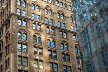 Facades of two Skyscrapers in Downtown Manhattan, New York City, USA - one Neo-Gothic, one Glass