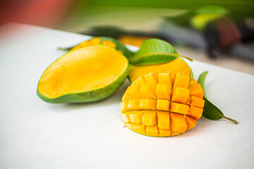 Ripe green and yellow mango fruit cut into pieces