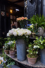 Flower shop. Branches with oleander flowers, daisies, roses, ferns, daffodils, spruce branches, hellebores, and anemones in vases