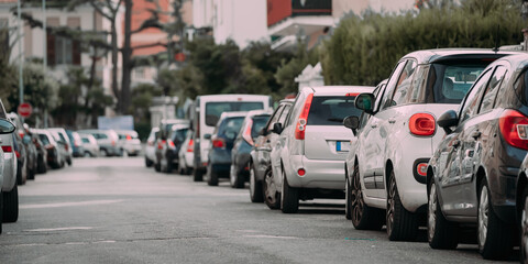 Cars Parked On Street In European City In Sunny Summer Day
