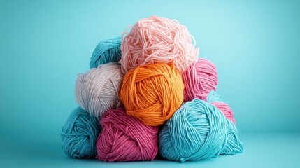 A vibrant collection of yarn balls in different shades of blue, pink, and orange, intricately arranged, symbolizing creativity and the art of crafting.