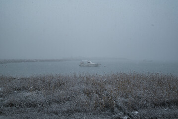Fishing boat in harbour in winter