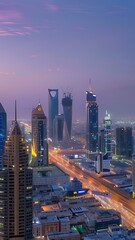 Fototapeta premium aerial cityscape at dusk tall buildings and lights illuminating the streets below in riyadh city