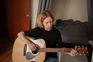 Guitar lessons at home, musician teaching chords to a beginner, lifestyle focused on skill...