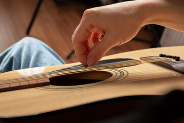 Hand Playing Acoustic Guitar Close-Up, music performance detail, acoustic guitar strings strumming