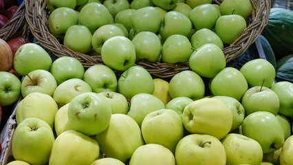 Green Apples Overflowing in a Basket