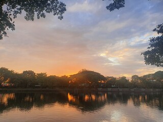 The sun is setting over a freshwater lake.