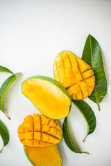 Ripe green and yellow mango fruit cut into pieces