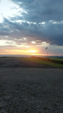 Vertical view of Sunset timelapse at an airstrip in Kericho, Kenya, with windsock in the scene