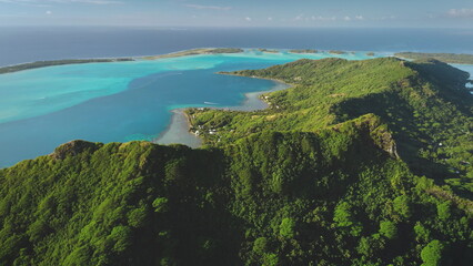 Aerial drone captures the breathtaking beauty of Bora Bora mountains, tropical island in French...