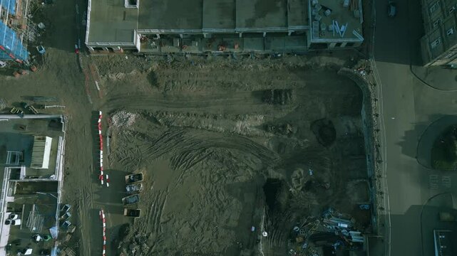 Construction site preparation and earthmoving activity captured from above in an urban area in Leeds, Kirkstall.