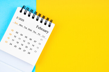 February 2025, Monthly desk calendar for 2025 year on yellow and blue background.
