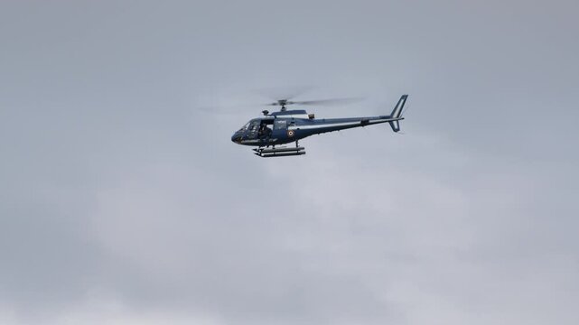 Professional pilot maneuvers a helicopter through a cloudy sky, showcasing the beauty of aviation and flight