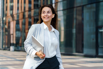 Business professional walking confidently in a modern urban environment during daylight hours