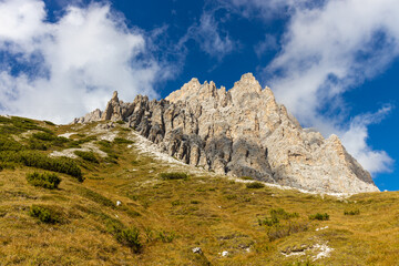 Fototapeta premium Autumn mountains. Alps in autumn colors. Dolomites beautiful yellow tree leaves autumn landscape. Alpine scenery of golden autumn