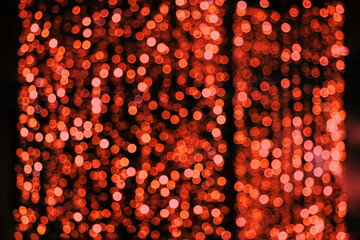 Glowing holiday blurred background with red lights