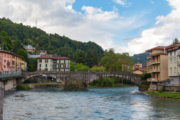 SAN PELLEGRINO TERME, ITALY - MAY 12, 2024: Old bridge over the river in San Pellegrino Terme