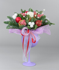 A traditional Christmas floral arrangement of green fir branches and flowers. New Year's decor for the interior
