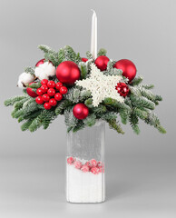A traditional Christmas floral arrangement of green fir branches and flowers. New Year's decor for the interior