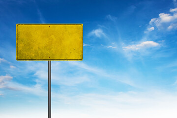 Blank warning road sign against blue sky.