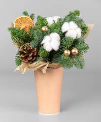 A traditional Christmas floral arrangement of green fir branches and flowers. New Year's decor for the interior