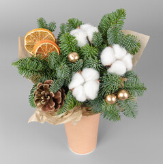 A traditional Christmas floral arrangement of green fir branches and flowers. New Year's decor for the interior