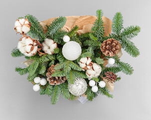 A traditional Christmas floral arrangement of green fir branches and flowers. New Year's decor for the interior