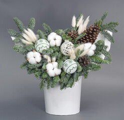 A traditional Christmas floral arrangement of green fir branches and flowers. New Year's decor for the interior