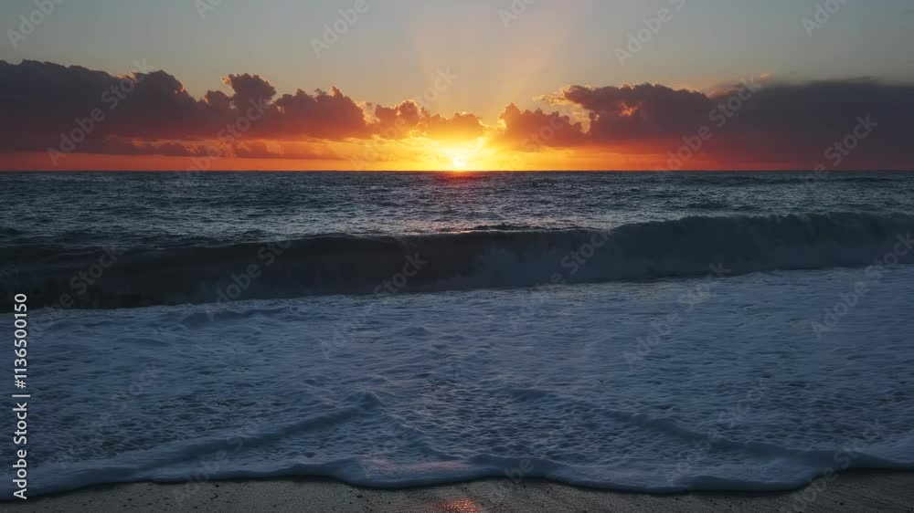 Wall mural stunning sunset over sea with vibrant colors reflecting on the water at the beach, 4k