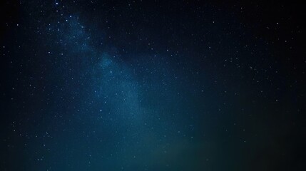 Captivating starry night sky with the Milky Way visible from an angle, dark blue and black background, scattered stars, perfect for night photography, evoking wonder, tranquility