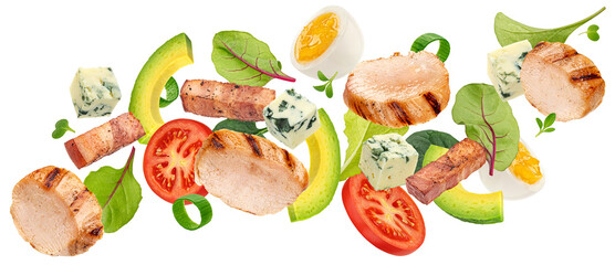 Falling Cobb salad with grilled chicken, eggs, tomato and bacon isolated on white background with clipping path